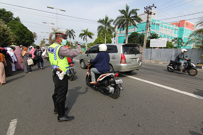 Pak polisi sibuk mengatur lalu lintas jalan yang dilewati oleh peserta pawai muharrom 1436 hijriyah TK Islam se kota Balikpapan